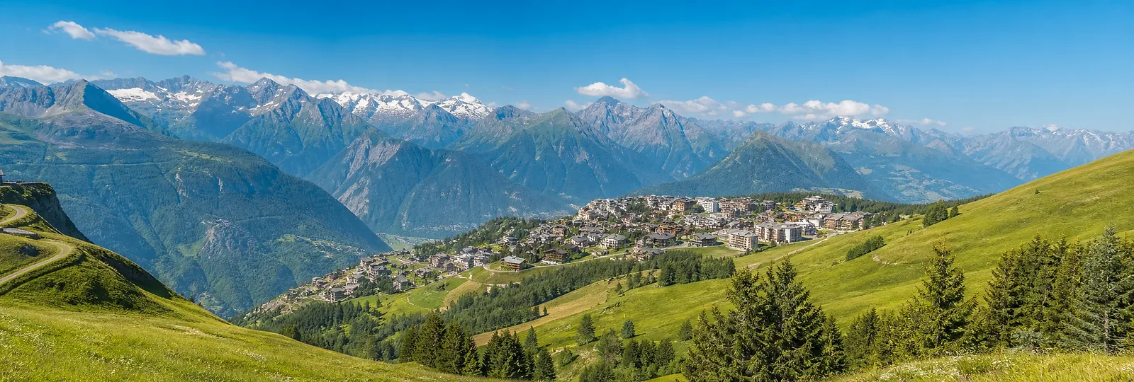 Alpe d'Huez summer meadows and mountain panorama