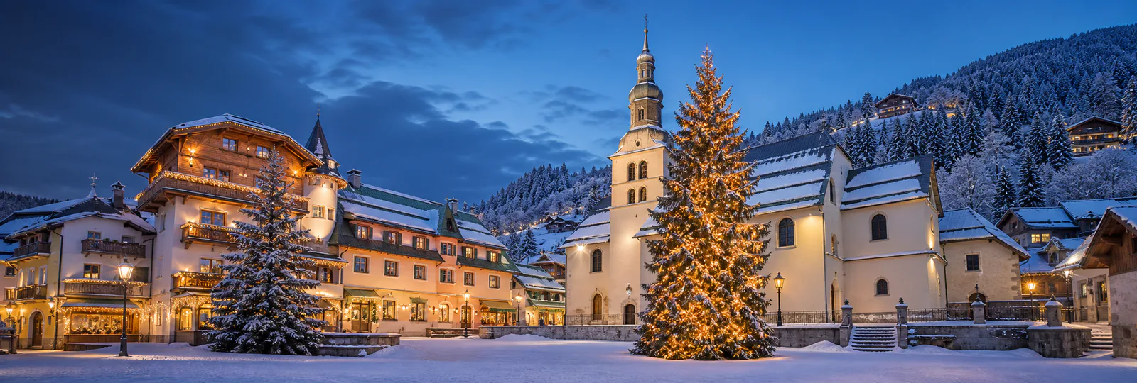Megeve village square, church and Christmas tree in winter