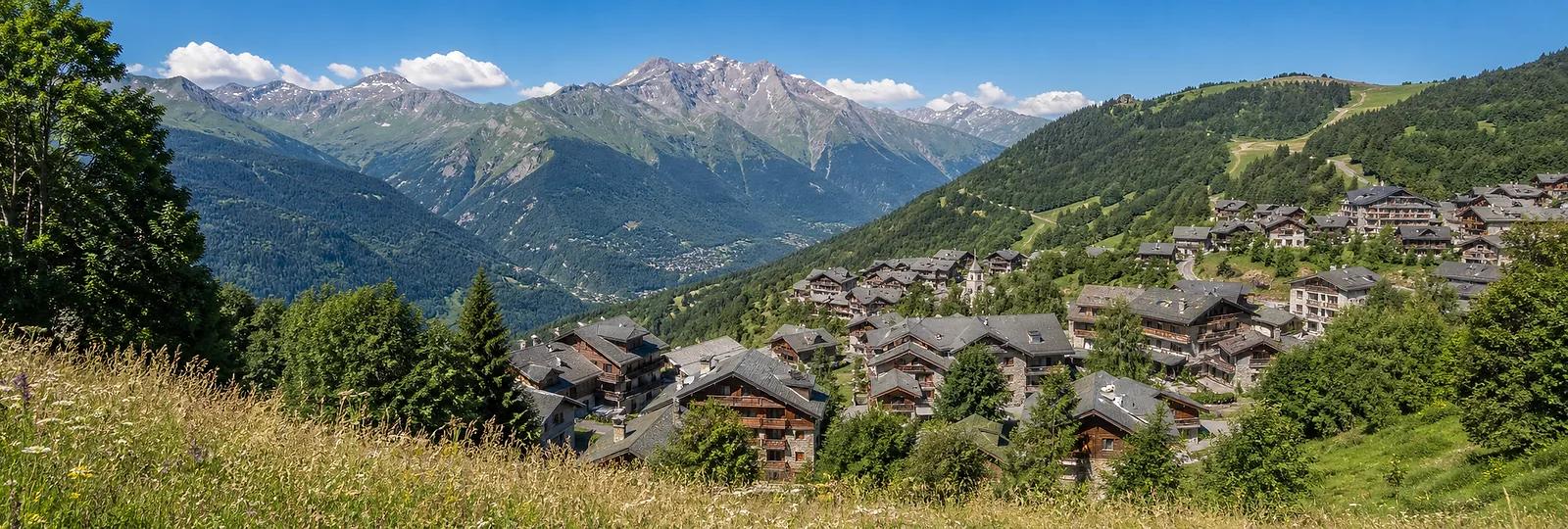 Valmorel summer village and green Grand Domaine mountain valley